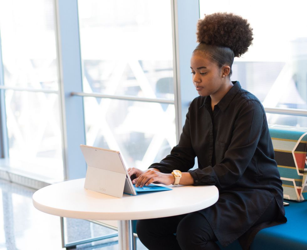 woman writing on a tablet